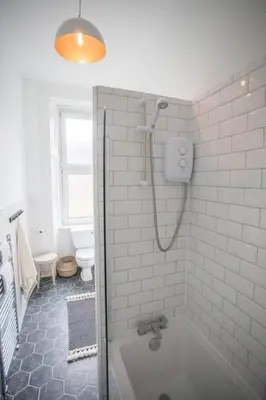 a bathroom with a shower and a bath tub at Stunning 2 bed property in heart of West End in Glasgow