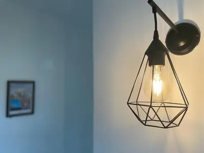 aendant light hanging from a wall with a picture at Cardonald Central in Glasgow