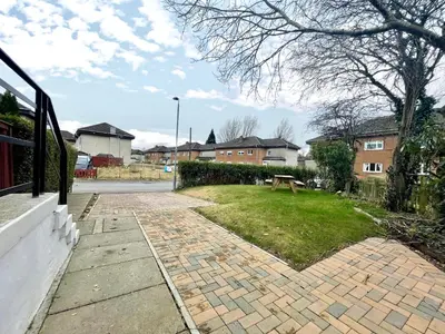 a brick walkway with a bench in a yard at Cardonald Central in Glasgow