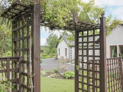 an entrance to a garden with a wooden gate at Torview House in Peebles