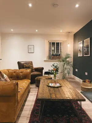 a living room with a couch and a coffee table at The Trossachs Collection in Kepculloch