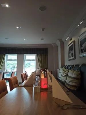 a conference room with a long table and chairs at Anchor Hotel and Seabed Restaurant in Tarbert