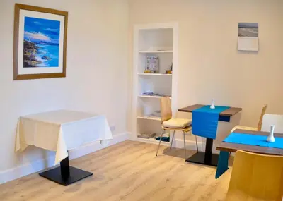 a room with a table and a table and chairs at An Cuan Bed & Breakfast in Bowmore