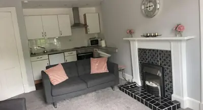 a living room with a couch and a fireplace at Our Wee Getaway in Rothesay