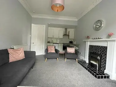 a living room with a couch and a fireplace at Our Wee Getaway in Rothesay
