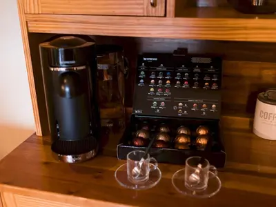 a coffee maker and a box of muffins on a counter at Beautiful, traditional 2 bed flat w free parking - Pass the Keys in Glasgow