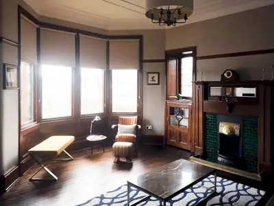 a living room with a fireplace and a table at Beautiful, traditional 2 bed flat w free parking - Pass the Keys in Glasgow