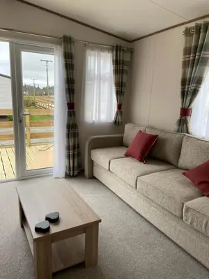 a living room with a couch and a table at The Wimbledon 70 in Dunoon