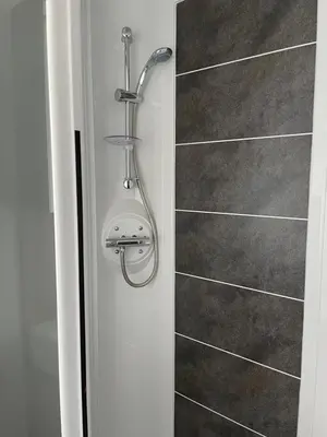 a shower with a shower head in a bathroom at The Wimbledon 70 in Dunoon