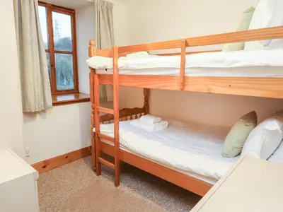 a bedroom with two bunk beds and a window at MacKintosh in Pitlochry