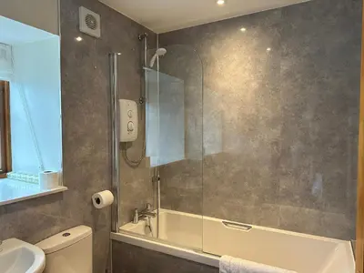 a bathroom with a shower and a toilet and a sink at MacKintosh in Pitlochry