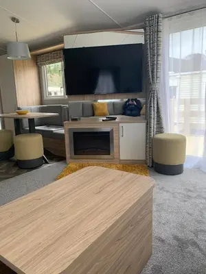 a living room with a couch and a tv at The Castleton Sea View 13 in Dunoon
