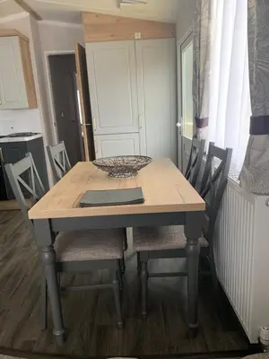 a dining room table and chairs in a kitchen at Swift Bordeaux Sea View No 3 in Dunoon