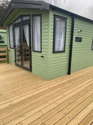 a green tiny house with a wooden deck at Swift Bordeaux Sea View No 3 in Dunoon