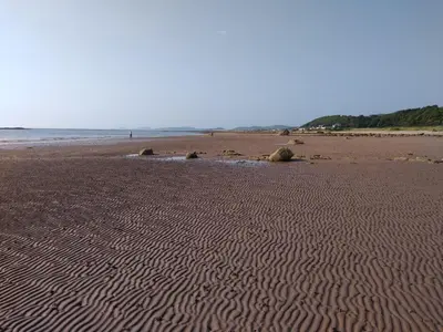 a sandy beach with ripples in the sand at Cleeves Cabins Arran Luxury Lodge with hot tub in Dalry