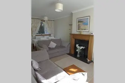 a living room with a couch and a fireplace at Sunny House with views to Edinburgh Skyline in Edinburgh