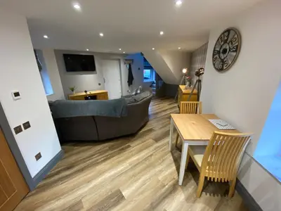 a living room with a couch and a table at holidayhomemoffat,com (Stable Cottage) in Moffat