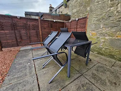a black table and chair sitting on a patio at ALLARDYCE in Kincardine