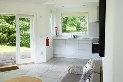 a kitchen with white cabinets and a table at Ardeonaig Hotel & Restaurant in Ardeonaig