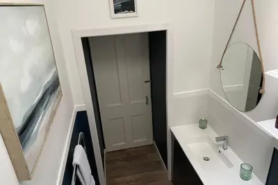 a bathroom with a sink and a mirror at The Old Jail Apartment, Inveraray in Inveraray