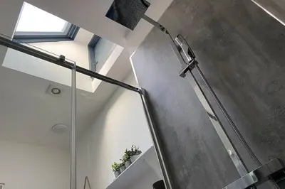 a bathroom with a shower with a glass door at The Old Jail Apartment, Inveraray in Inveraray