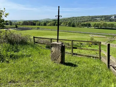 a pole in a field next to a fence at Wellsfield Farm Holiday Lodges in Stirling
