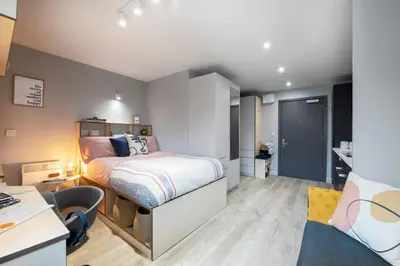 a bedroom with a bed and a desk with a chair at Silk Mill Edinburgh in Edinburgh