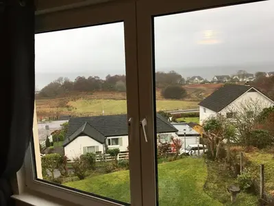 a window with a view of some houses at Brecbennoch in Oban