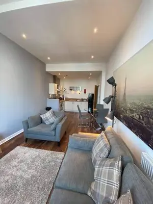 a living room with a couch and two chairs at Dreamhouse at Oswald Street, City Centre in Glasgow