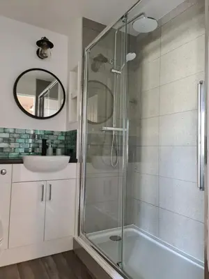 a bathroom with a glass shower and a sink at EDEN Apartment, Oban in Oban