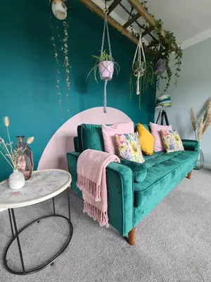 a living room with a green couch and a table at EDEN Apartment, Oban in Oban