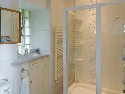 a bathroom with a shower and a sink at Cluniter Cottage in Innellan