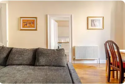 a living room with a couch and a table at 3 Bed Central Apartment - Pet Friendly & Parking in Edinburgh