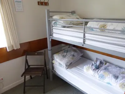 a room with two bunk beds and a chair at Inveraray Hostel in Inveraray