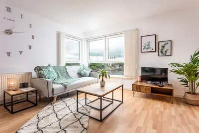 a living room with a couch and a tv at Walker Suite No54 - Donnini Apartments in Kilmarnock