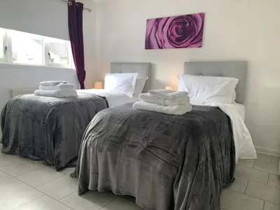 two beds in a room with towels on them at Dada House in Glasgow