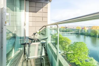 a balcony with a view of a river at Luxury Riverview City Centre Apartment in Glasgow
