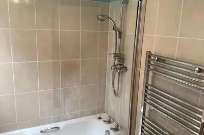 a bathroom with a shower and a bath tub at Ferry View in Largs