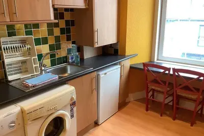 a kitchen with a sink and a washing machine at Ferry View in Largs