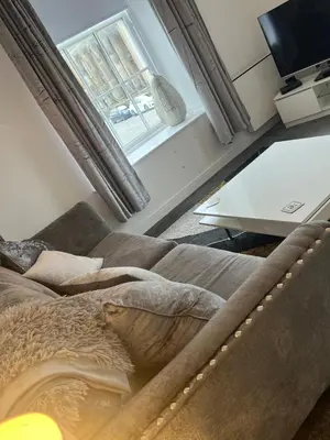 a living room with a couch and a window at Ayr Cozy Corner Apartment in Ayr
