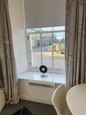 a window with a lamp on a radiator in a room at Ayr Cozy Corner Apartment in Ayr