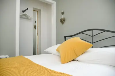 a yellow pillow sitting on top of a bed at McCaig's Way in Oban