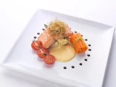 a white plate with sushi and vegetables on it at North West Castle Hotel in Stranraer