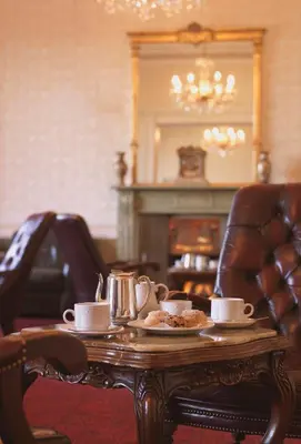 a table with cups and plates of food on it at North West Castle Hotel in Stranraer