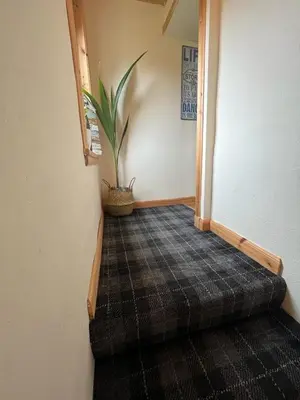 a stairway with a potted plant in a room at Taigh Mara(Marine House) 2 bed Apartment in Fort William
