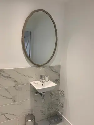 a bathroom with a sink and a mirror at The Bothy at Arndean in Dollar