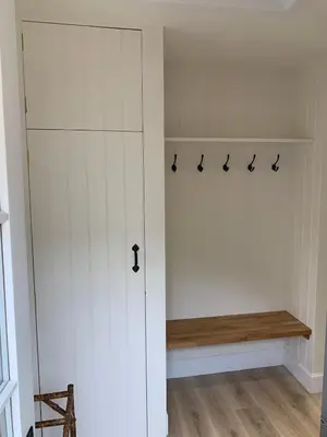 a white closet with a bench in a room at The Bothy at Arndean in Dollar
