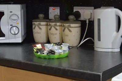 a counter top with a green plate of food on it at 3 Dialknowe Holiday Cottage - Wanlockhead - 3 Bedrooms in Wanlockhead