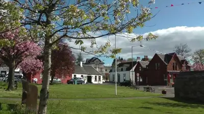 a small town with houses and a park at Braeside Guest House, Loch Lomond in Drymen