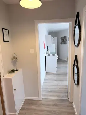 a hallway with a hallway leading to a kitchen at No 19 Serviced Apartment in Ayr